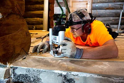 Der Parkettleger bearbeitet den Boden mit der Festool Oberfräse